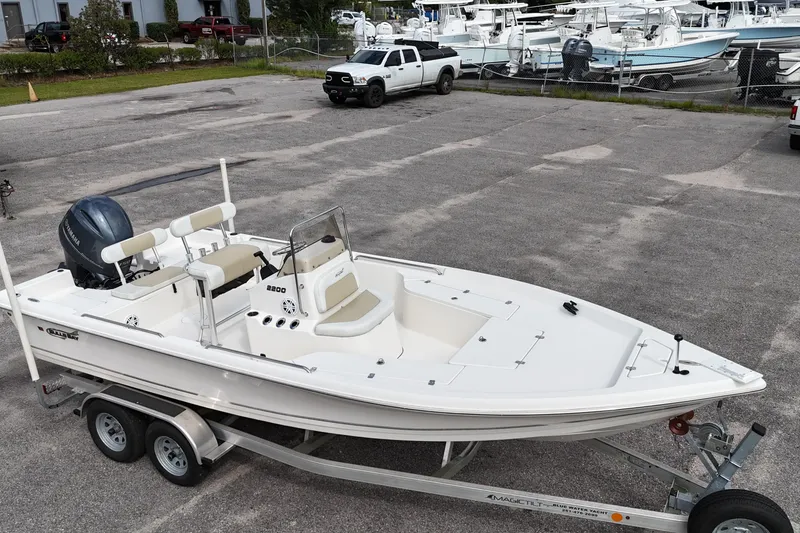 Slide: The Image of 2023 Bulls Bay 2200 boat on trailer in parking lot, featuring Yamaha outboard motor. - 11