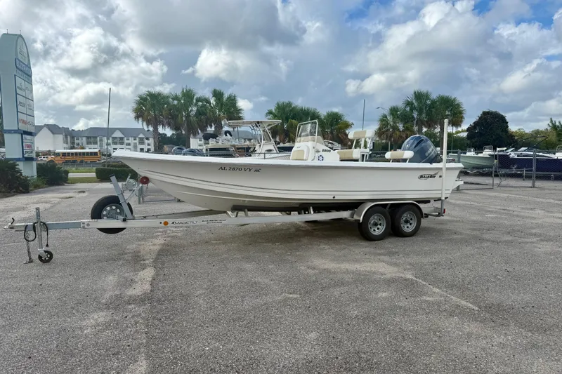 Slide: The Image of 2023 Bulls Bay 2200 boat on trailer in parking lot, cloudy sky background. - 2