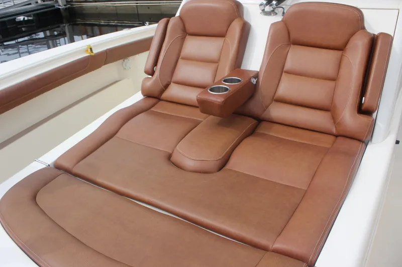 Slide: The Image of Luxurious brown leather seating on 2018 Scout 380 LXF boat with cup holders. - 15