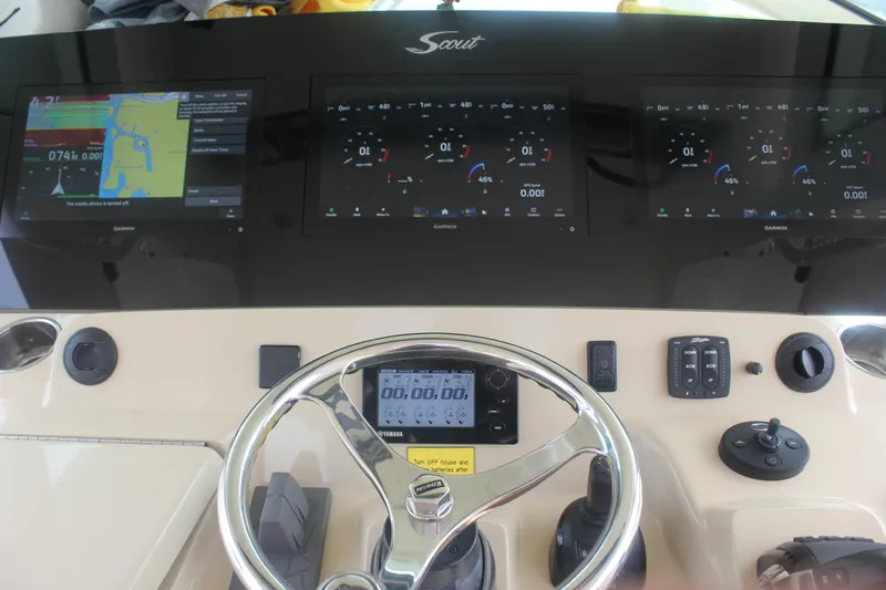 Slide: The Image of 2018 Scout 380 LXF boat dashboard with Garmin displays and steering wheel. - 19