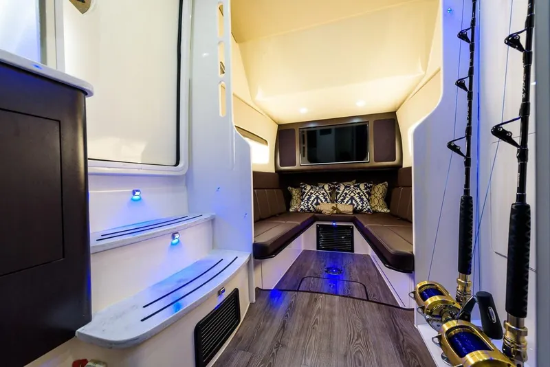 Slide: The Image of Manufacturer Provided Image: Luxurious interior of 2018 Scout 380 LXF boat with seating and fishing rods. - 22