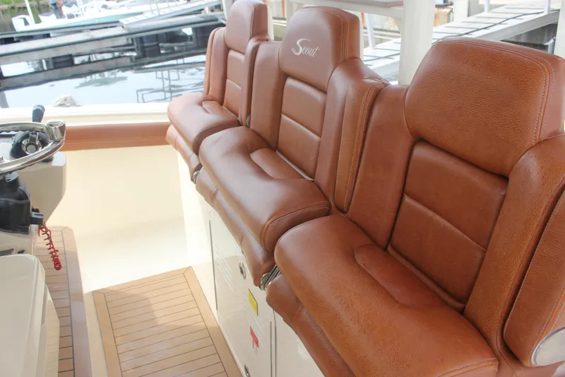 Slide: The Image of Luxurious brown leather seating on 2018 Scout 380 LXF boat, docked at marina. - 24