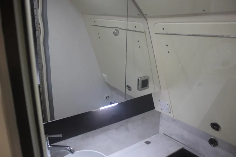 Slide: The Image of Interior of 2018 Scout 380 LXF boat bathroom with sink and mirror. - 30