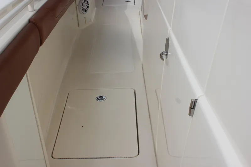 Slide: The Image of 2018 Scout 380 LXF boat interior with sleek design and storage compartments. - 43