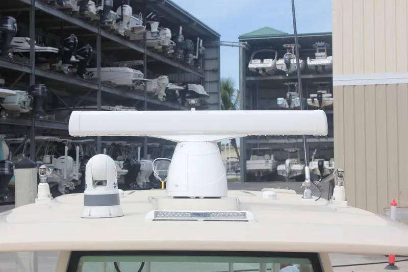 Slide: The Image of 2018 Scout 380 LXF boat radar and equipment on deck, with marina background. - 46
