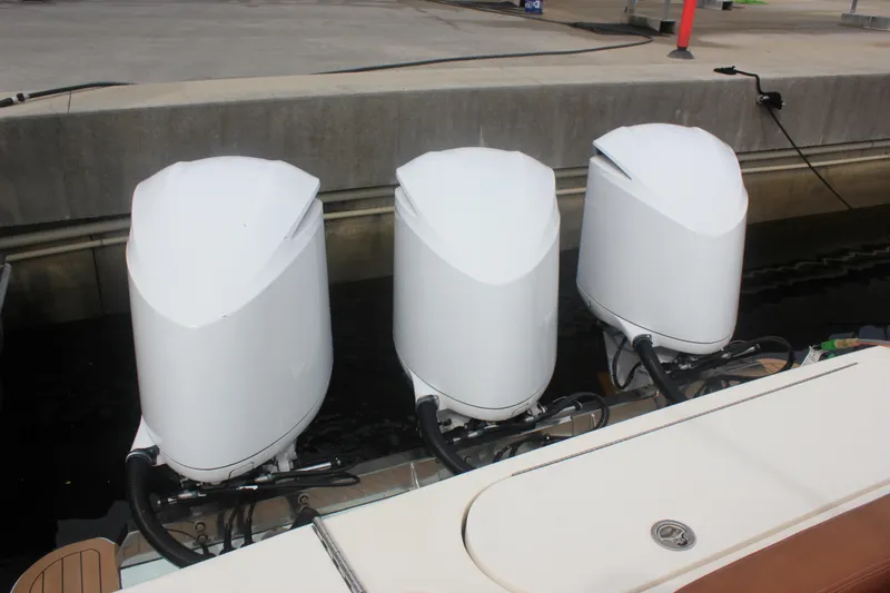 Slide: The Image of 2018 Scout 380 LXF boat with triple outboard engines at dockside. - 47