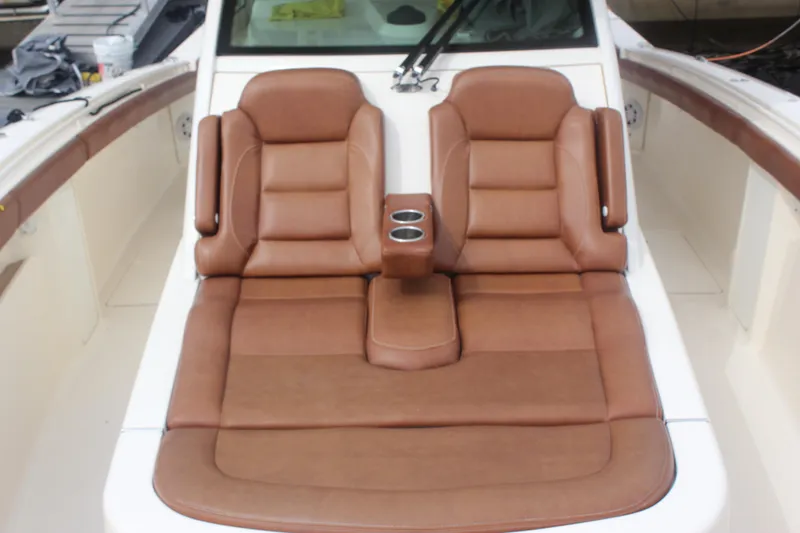Slide: The Image of Luxurious brown leather seating on 2018 Scout 380 LXF boat, featuring cup holders. - 48