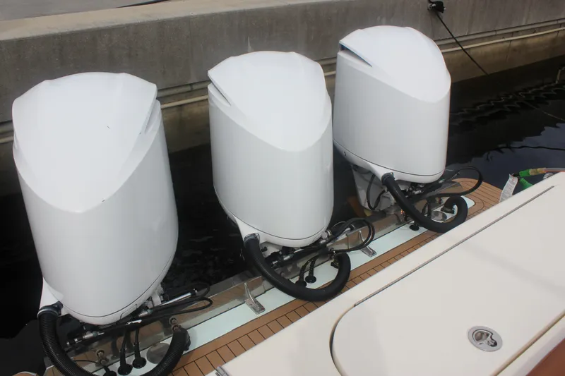 Slide: The Image of Triple outboard engines on a 2018 Scout 380 LXF boat at a dock. - 49