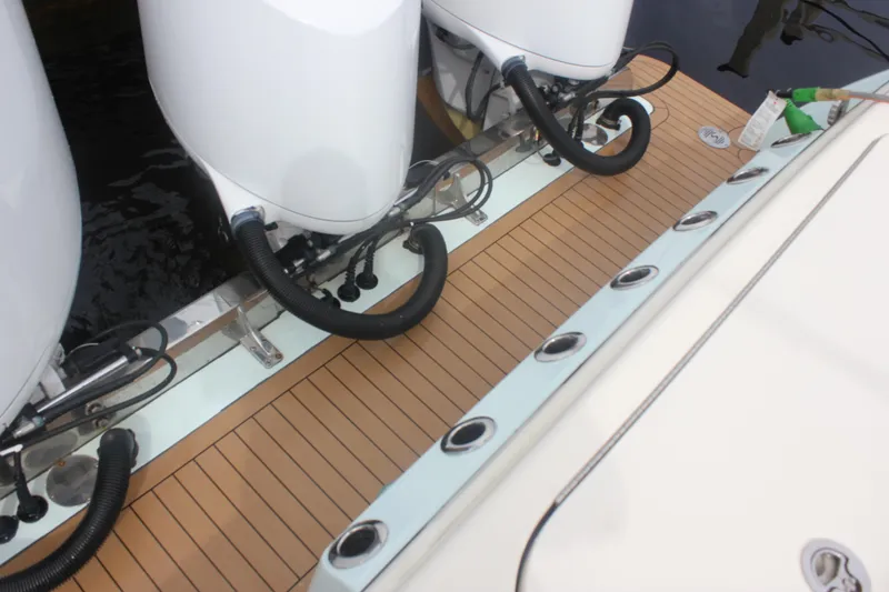 Slide: The Image of 2018 Scout 380 LXF boat with triple outboard engines and teak deck. - 50