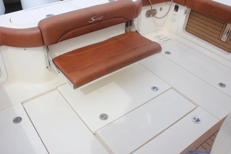Slide: The Image of 2018 Scout 380 LXF boat interior with brown leather seating and storage compartments. - 53