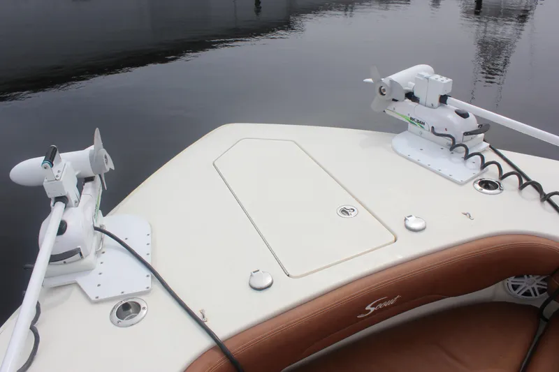 Slide: The Image of 2018 Scout 380 LXF boat deck with dual trolling motors on calm water. - 55