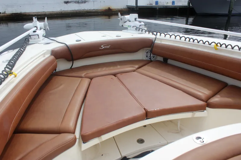 Slide: The Image of 2018 Scout 380 LXF boat with brown cushioned seating in the bow area. - 59