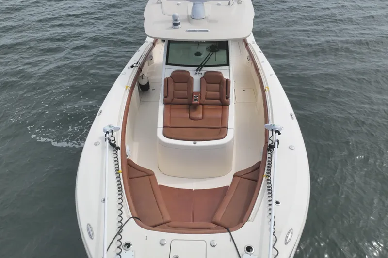 Slide: The Image of 2018 Scout 380 LXF boat with brown seating on open water. - 6