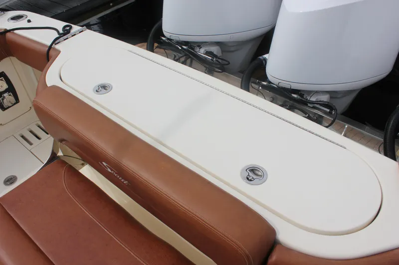 Slide: The Image of 2018 Scout 380 LXF boat seating and storage area with dual engines. - 64