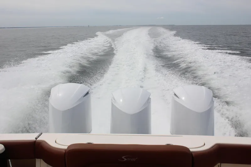 Slide: The Image of 2018 Scout 380 LXF boat cruising with powerful triple engines on open water. - 72
