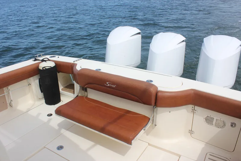 Slide: The Image of 2018 Scout 380 LXF boat with brown seating and four outboard engines on water. - 74