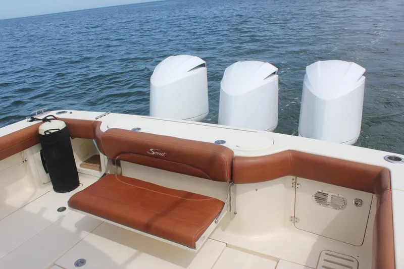 Slide: The Image of 2018 Scout 380 LXF boat with brown seating and four outboard engines on the water. - 75