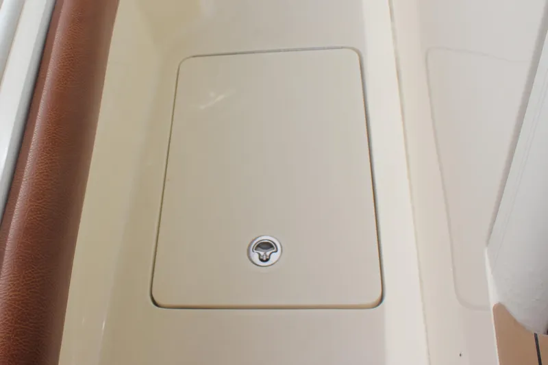 Slide: The Image of 2018 Scout 380 LXF boat storage compartment with brown trim. - 79