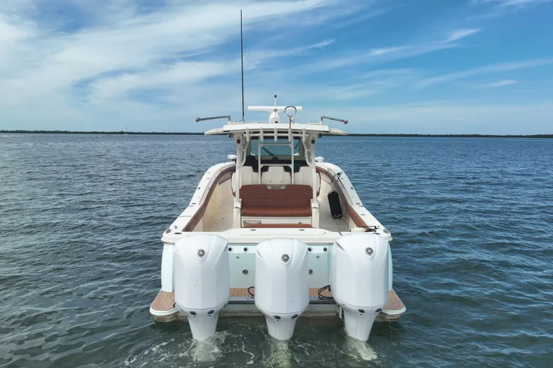 Slide: The Image of 2018 Scout 380 LXF boat with triple engines on open water. - 87