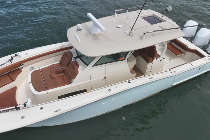 Slide: The Image of 2018 Scout 380 LXF boat on water, featuring sleek design and luxurious seating. - 95