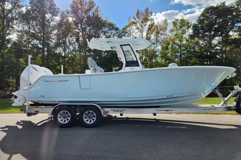 The Image of 2026 Sportsman Open 262 Center Console boat on trailer, parked outdoors. - 0