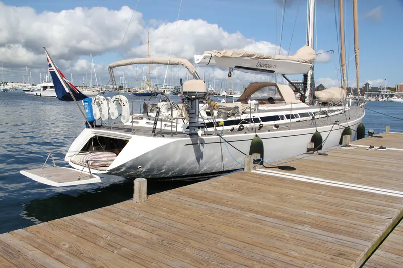 The Image of Luxury Nautor Swan 62 yacht docked at marina, 2004 model, with clear skies and calm waters. - 1