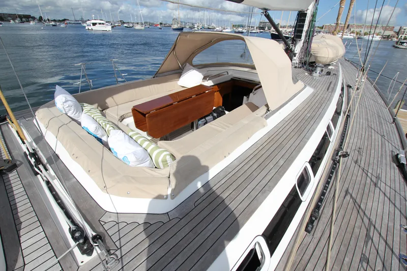 Slide: The Image of Luxurious 2004 Nautor Swan 62 yacht deck with comfortable seating and scenic marina view. - 12