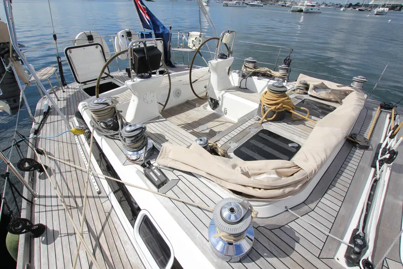Slide: The Image of 2004 Nautor Swan 62 yacht deck with dual steering wheels and winches. - 13