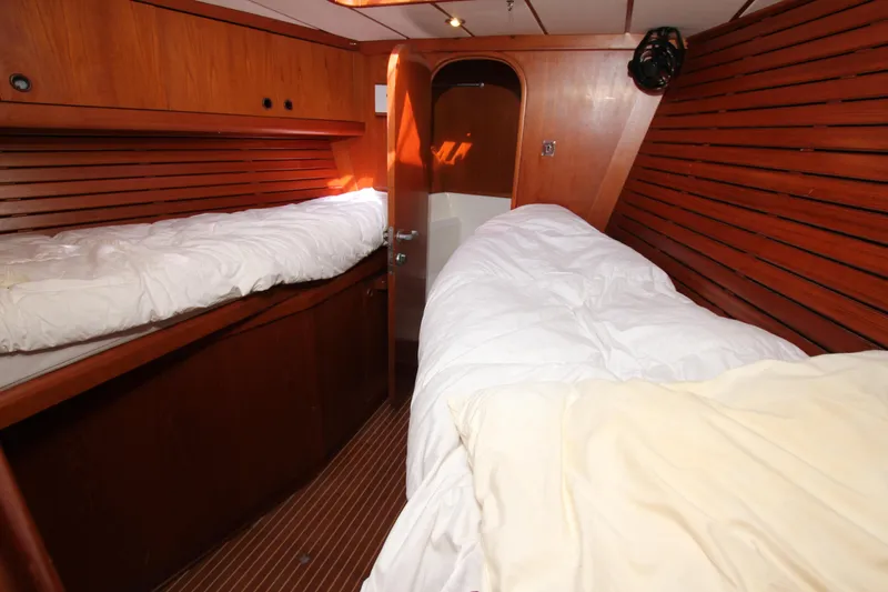 Slide: The Image of Interior cabin of 2004 Nautor Swan 62 yacht with wooden paneling and twin beds. - 23