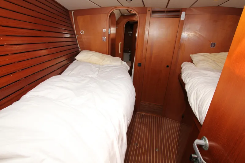 Slide: The Image of Interior cabin of 2004 Nautor Swan 62 yacht with twin beds and wooden paneling. - 24