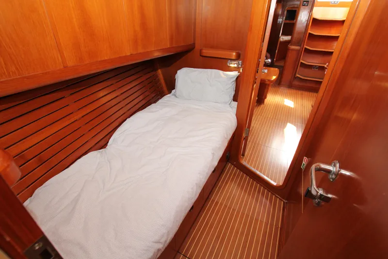 Slide: The Image of Cozy cabin interior of 2004 Nautor Swan 62 yacht with wooden finish and single bed. - 26