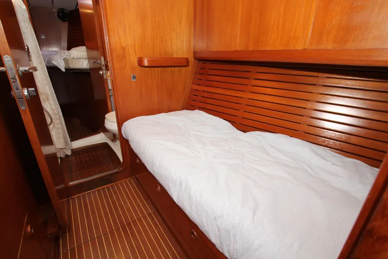 Slide: The Image of Cozy cabin interior of 2004 Nautor Swan 62 yacht with wooden finish and bed. - 27