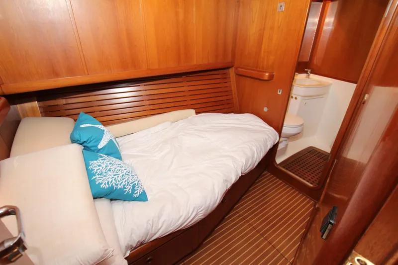 Slide: The Image of Cozy cabin interior of 2004 Nautor Swan 62 yacht with wooden finish and ensuite bathroom. - 28