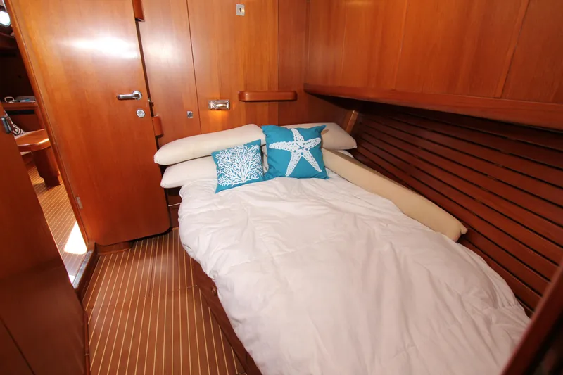 Slide: The Image of Cozy cabin interior of 2004 Nautor Swan 62 yacht with wooden finish and decorative pillows. - 30