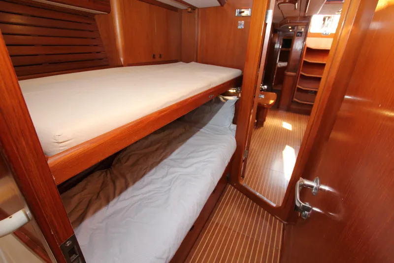 Slide: The Image of Interior of 2004 Nautor Swan 62 yacht with wooden bunk beds and hallway. - 32
