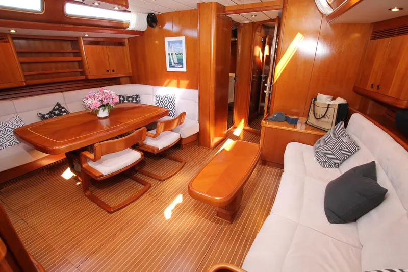 Slide: The Image of Luxurious interior of 2004 Nautor Swan 62 yacht with elegant wood finish and cozy seating. - 36