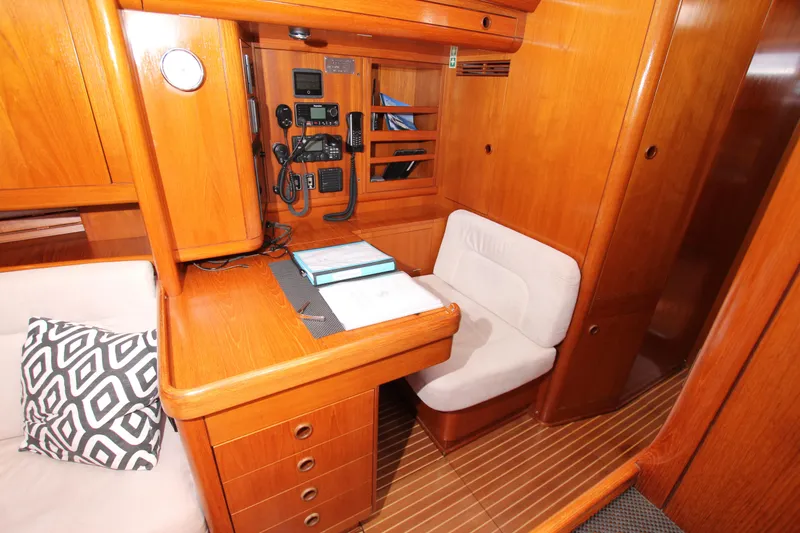 Slide: The Image of Nautor Swan 62 yacht interior, 2004 model, featuring a navigation station with wooden finish. - 40