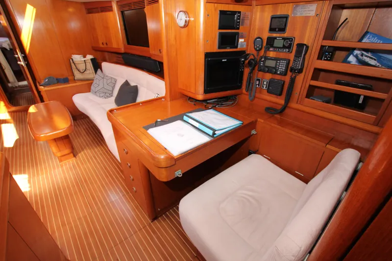 Slide: The Image of Luxurious 2004 Nautor Swan 62 yacht interior with navigation station and cozy seating area. - 42