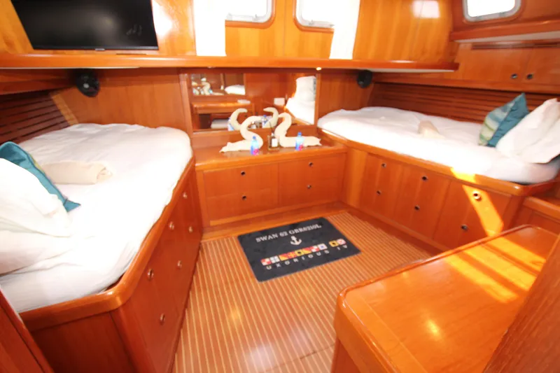 Slide: The Image of Luxurious 2004 Nautor Swan 62 yacht cabin with twin beds and elegant wood finish. - 44