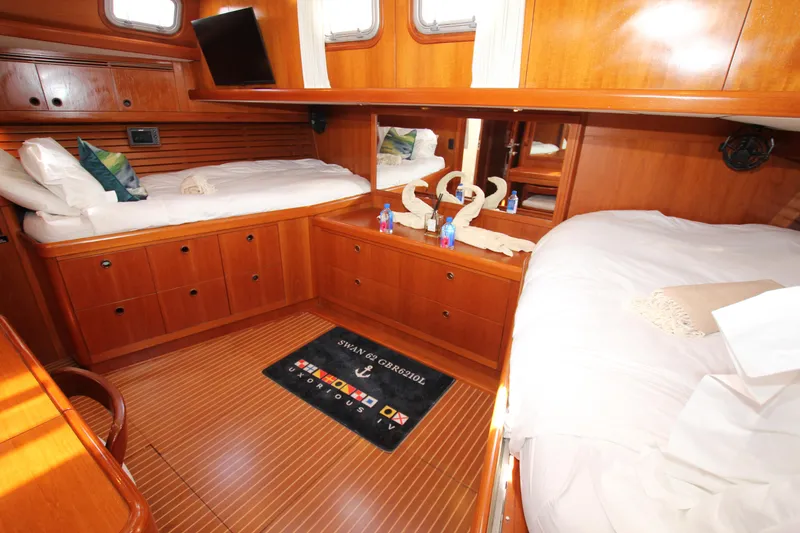 Slide: The Image of Luxurious cabin interior of 2004 Nautor Swan 62 yacht with wooden furnishings and cozy beds. - 45