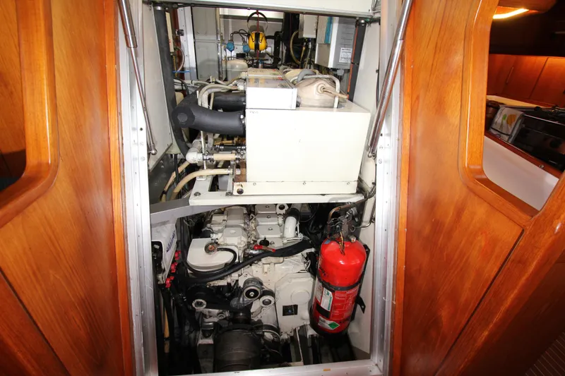 Slide: The Image of Engine room of 2004 Nautor Swan 62 yacht with visible machinery and fire extinguisher. - 48