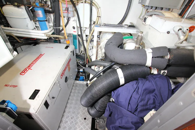 Slide: The Image of Engine room of 2004 Nautor Swan 62 yacht with Westerbeke generator and various mechanical components. - 49