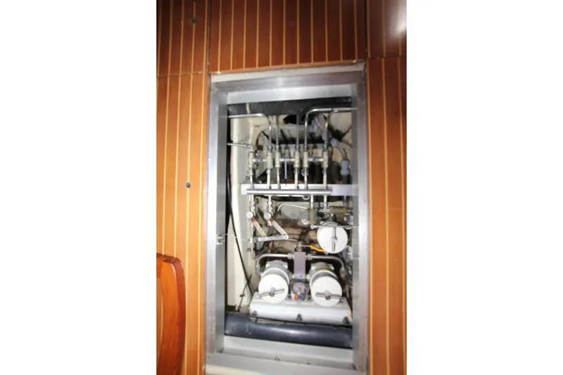 Slide: The Image of Engine compartment of 2004 Nautor Swan 62 yacht, showcasing mechanical components and piping. - 50
