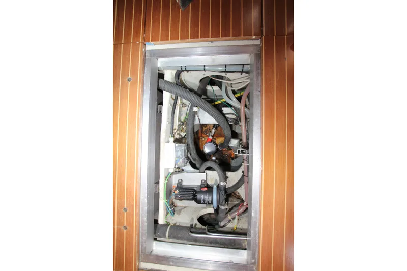 Slide: The Image of Engine compartment of 2004 Nautor Swan 62 yacht with visible hoses and components. - 51