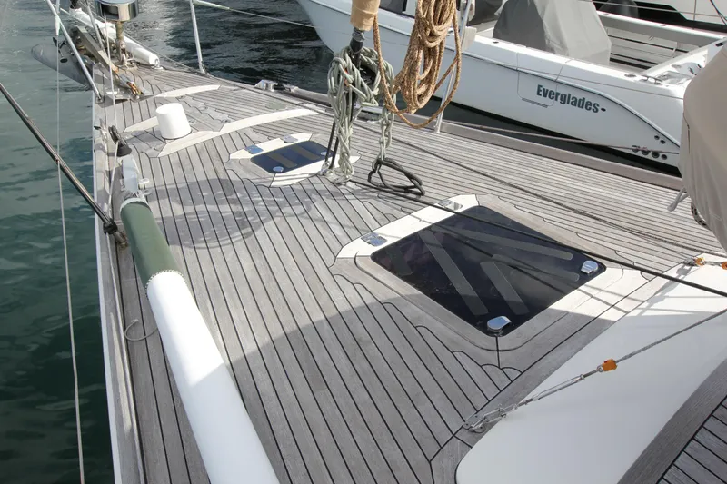 Slide: The Image of Deck of 2004 Nautor Swan 62 yacht with sleek wooden finish and hatch windows. - 6