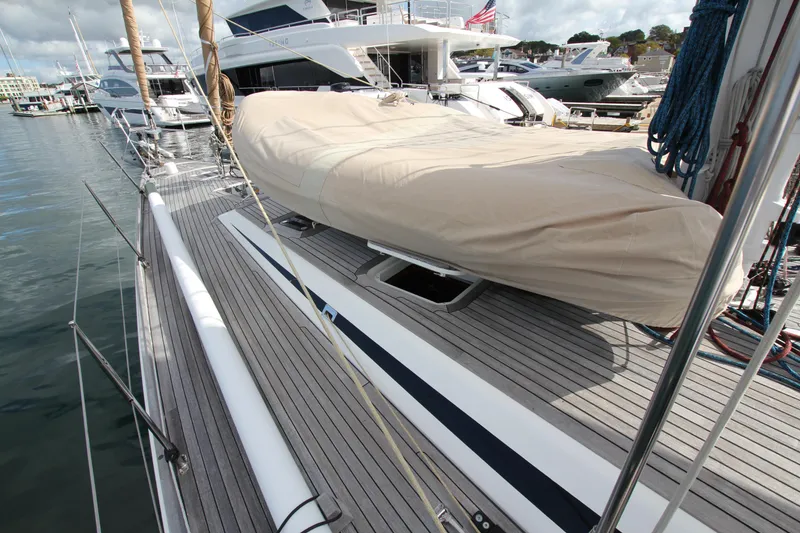 Slide: The Image of 2004 Nautor Swan 62 yacht docked, featuring a covered deck and sleek design. - 7