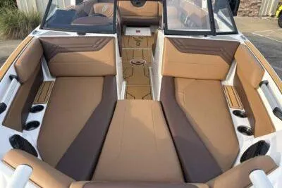 Slide: The Image of 2026 ATX Surf Boats 24 Type-S interior with tan and brown seating, cup holders, and sleek design. - 10