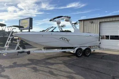 Slide: The Image of 2026 ATX Surf Boats 24 Type-S on trailer, parked outdoors near a building. - 5