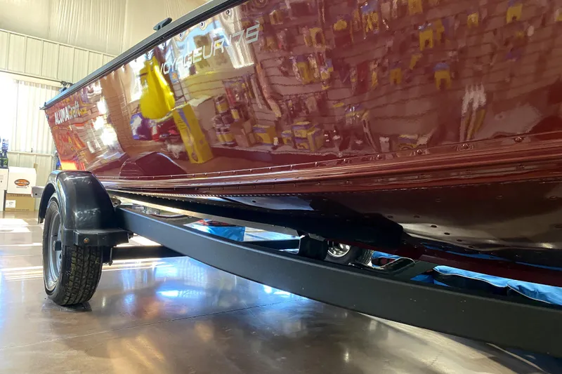 Slide: The Image of 2026 Alumacraft Voyageur 175 Sport boat on trailer in a showroom. - 14