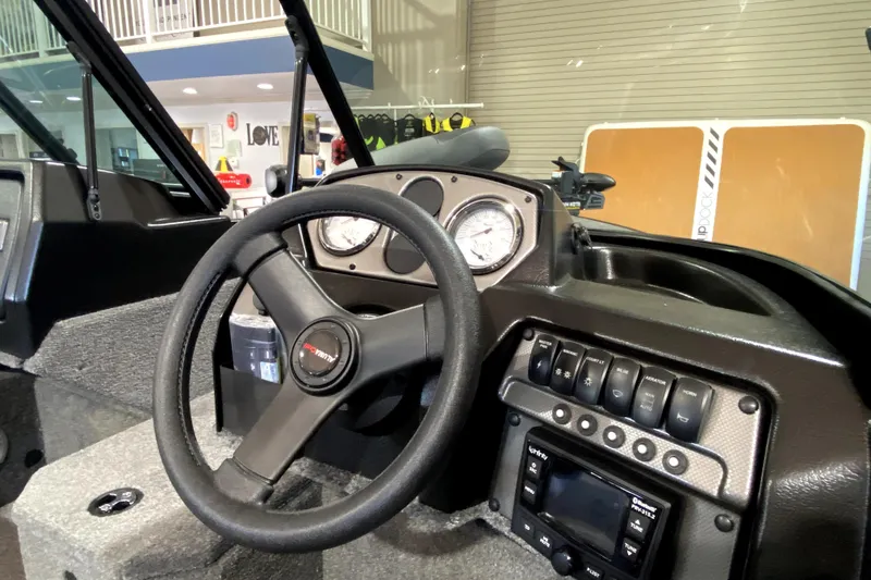 Slide: The Image of 2026 Alumacraft Voyageur 175 Sport dashboard with steering wheel and control panel. - 7